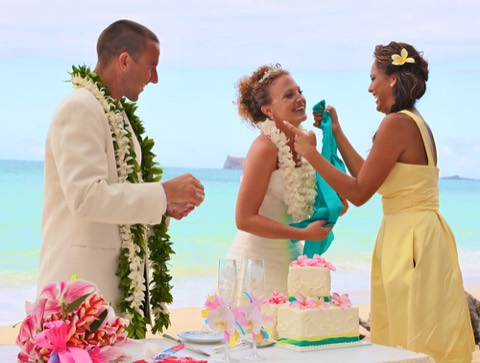 The maid of honor in yellow helps the bride clean up after the cake fight