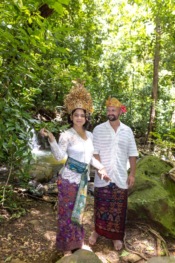 Couple in traditional Balinese-style attire standing in the lush Nuuanu forest