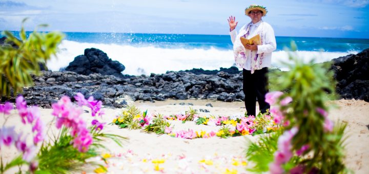 Kahu Paul facilitates a wedding ceremony on the beach at Makapuu