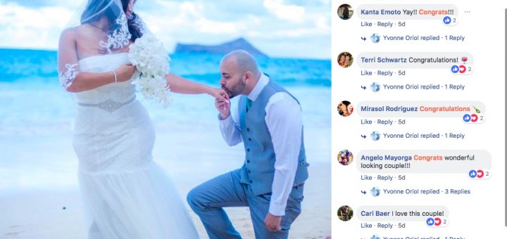 The groom kissing the hand of his wife