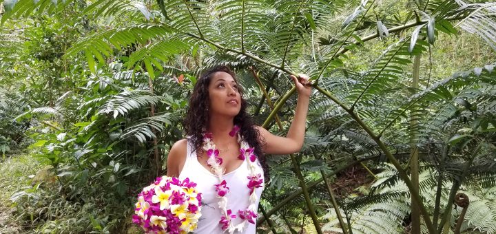 Bride in the forest with her yellow and purple orchid flowers