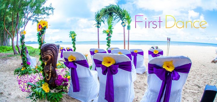 Purple sashes around white chair cover and yellow hibiscus in the bow