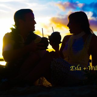 Sunset in waikiki beach while toasting the coconut drinks