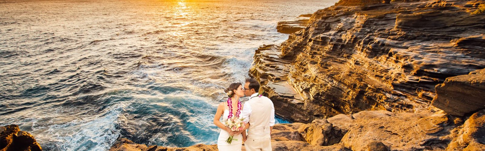 Wedding couple on the lava rocks at sunset on Oahu